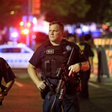  Dallas police stand watch near the scene where four Dallas police officers were shot and killed on July 7, 2016 in Dallas, Texas.