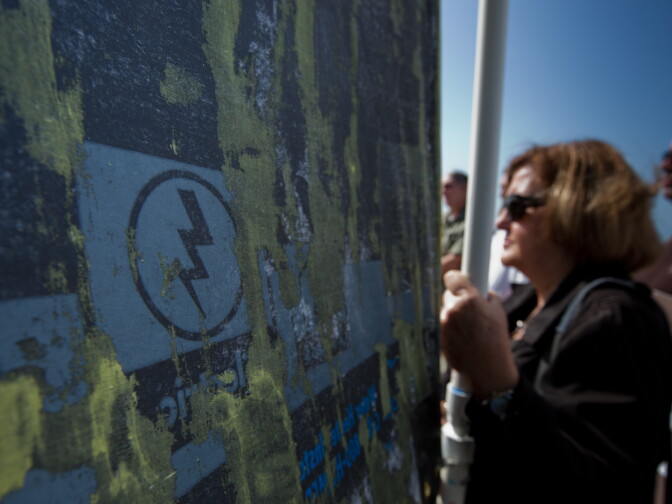 Anti-nuclear protesters hold a banner on San Onofre State Beach near the inactive nuclear plant on April 6, 2012.