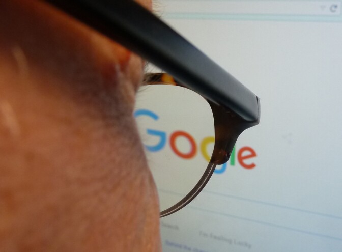 A journalist looks at the new Google logo at his work station in Washington, DC on September 1, 2015. Google on Tuesday refreshed its logo to better suit mobile devices that are supplanting desktop computers when it comes to modern Internet lifestyles. Google's logo keeps its four-color scheme but shifts to a soft sans-serif font. The company is also replacing the well-known blue lower case "g" icone with an upper-case "G" combining blue, green, red and yellow colors. The 17-year-old Internet company is keen to follow users of its online products onto new generations of Internet-linked devices such as smartphones, tablets, and watches.AFP PHOTO / EVA HAMBACH        (Photo credit should read EVA HAMBACH/AFP/Getty Images)