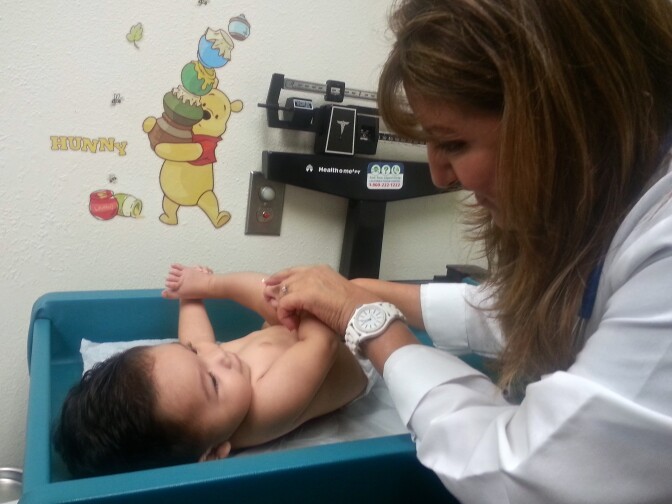 Nurse Practitioner Aura Veliz examines 5-month-old Johnny Ceballos during a well baby visit at Aurora Medical Center. 