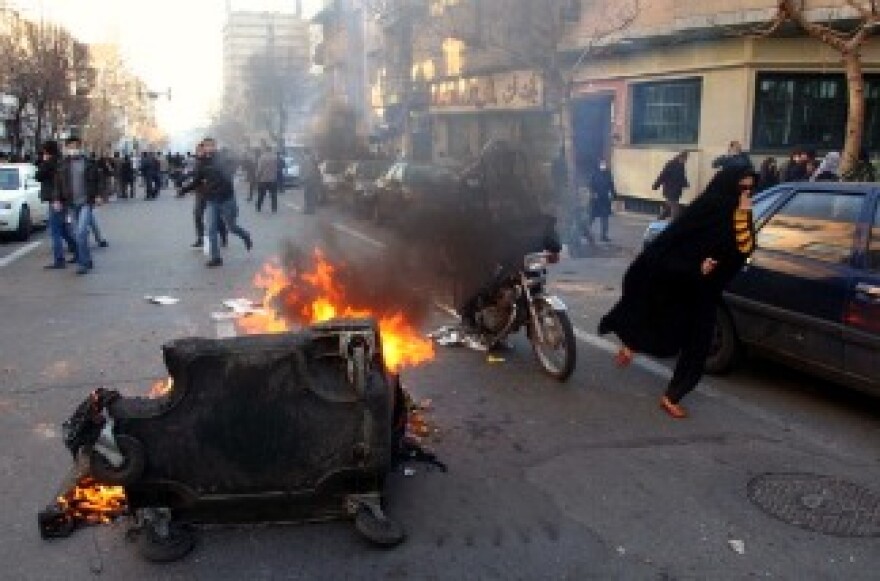 A garbage container is set on fire as Iranian protesters stage an anti-government demonstration in Tehran on February 14, 2011.