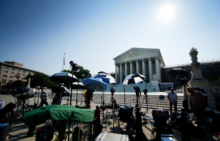 Members of the media camp outside the US Supreme Court June 21, 2012, in Washington, DC as the Supreme Court is expected to hand down its ruling.