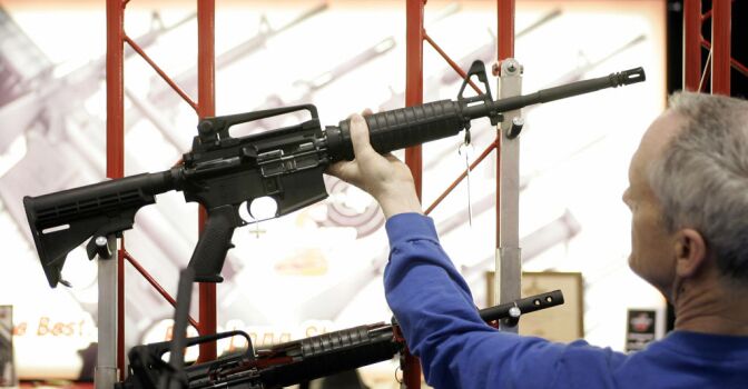 Bill Saxler of Milwaukee holds a Bushmaster rifle 19 May, 2006, during the 135th National Rifle Association (NRA) Annual Convention in Milwaukee, Wisconsin. The show runs through 21 May. 