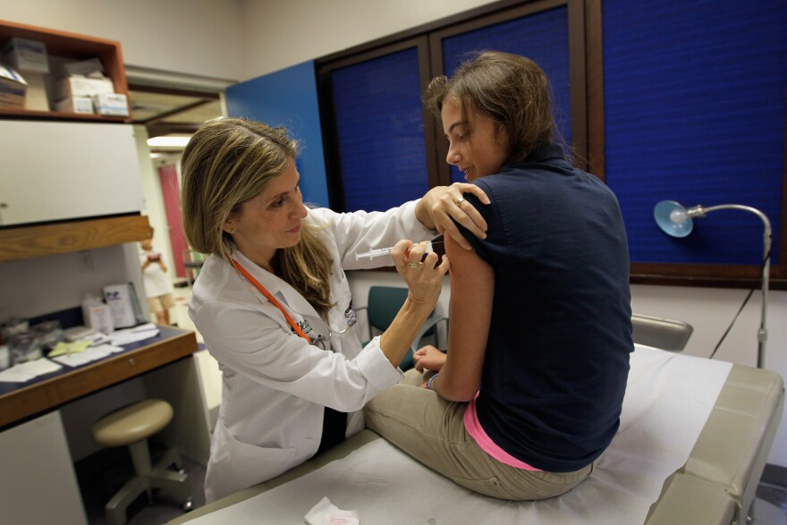 MIAMI, FL - SEPTEMBER 21:  University of Miami pediatrician Judith L. Schaechter, M.D. (L) gives an HPV vaccination to a 13-year-old girl in her office at the Miller School of Medicine on September 21, 2011 in Miami, Florida. The vaccine for human papillomavirus, or HPV, is given to prevent a sexually transmitted infection that can cause cancer. Recently the issue of the vaccination came up during the Republican race for president when Rep. Michele Bachmann (R-MN) called the vaccine to prevent cervical cancer "dangerous" and said that it may cause mental retardation, but expert opinion in the medical field contradicts her claim. Texas Gov. Rick Perry, also a presidential contender, has taken heat from some within his party for presiding over a vaccination program in his home state. (Photo by Joe Raedle/Getty Images)