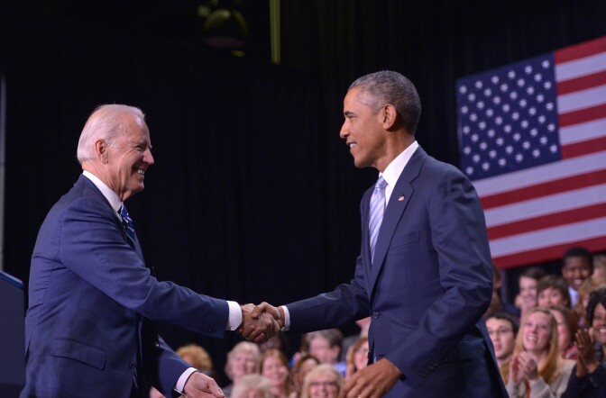 US Vice President Joe Biden (L) shake hands with US President Barack Obama after introducing him at Pellissippi State Community College in Knoxville, Tennessee on January 9, 2015. 