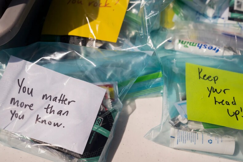 Ziplock Bags with inspirational messages and necessities such as toothpaste in them.