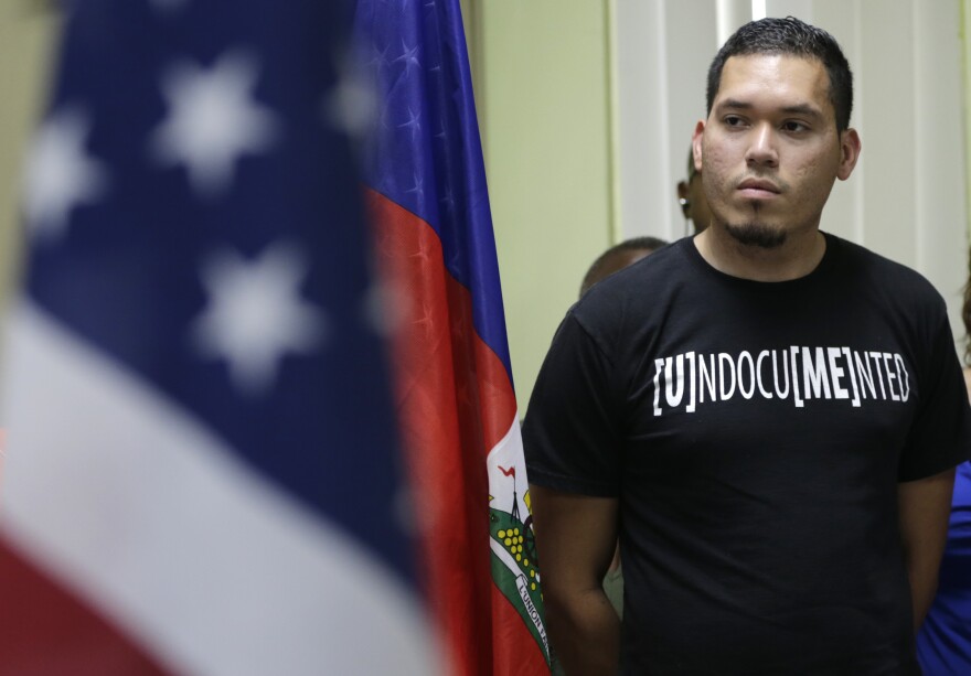 Julio Calderon, 28, an undocumented immigrant from Honduras, listens after speaking in favor of renewing Temporary Protected Status (TPS) for immigrants from Central America and Haiti now living in the United States, during a news conference Monday, Nov. 6, 2017, in Miami.