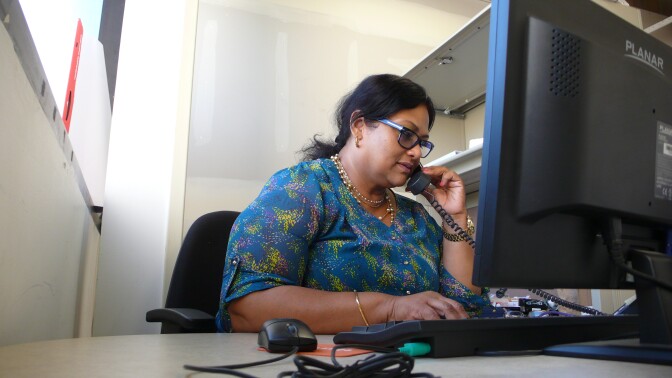 Nasima Rahi, a certified educator for California Covered, shares information about the Affordable Care Act with visitors to Asian Pacific Health Care Venture.  