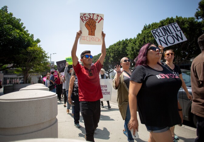Protesters circle the Immigration and Customs Enforcement processing center in protest to the Trump administrations family separations related to the zero-tolerance policy along the border, in Los Angeles, California, June 21, 2018.