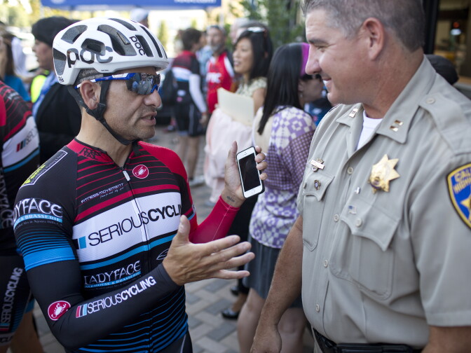 Cyclist Aaron Gallardo of Woodland Hills talks with California Highway Patrol West Valley Division Captain Kevin Gordon after a press conference for the Three Feet for Safety Act. Starting September 16, drivers must give cyclists at least three feet of clearance.