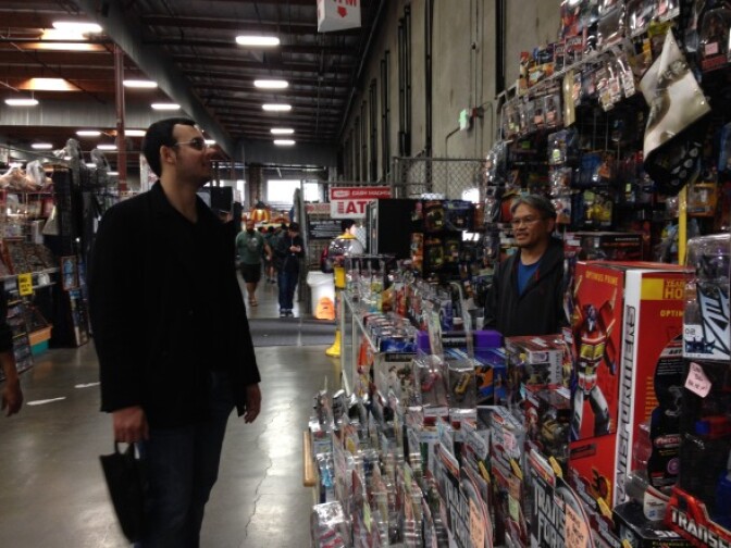A passerby takes in the figurine offerings at Robert's booth in Frank & Son.