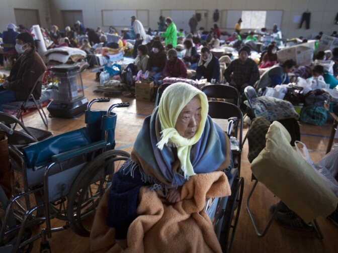 Refugees, including 53 who were saved from a retirement home, take shelter inside a school gym in the leveled city of Kesennuma, northeastern Japan. 