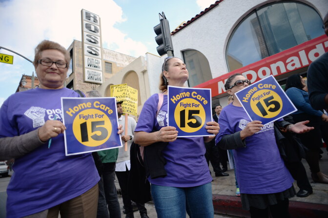 Home healthcare workers join fast food workers and their supporter at a rally and march to demand an increase of the minimum wage to 15USD per hour, in Los Angeles on December 4, 2014. The nationwide protest is expected to reach 190 US cities.  AFP PHOTO / ROBYN BECK        (Photo credit should read ROBYN BECK/AFP/Getty Images)