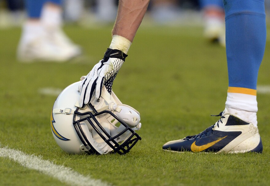 SAN DIEGO, CA-OCTOBER-14:  John Phillips #83 of the San Diego Chargers picks up his helmet during the football game against Indianapolis Colts at Qualcomm Stadium October 14, 2013 in San Diego, California.  (Photo by Kevork Djansezian/Getty Images)