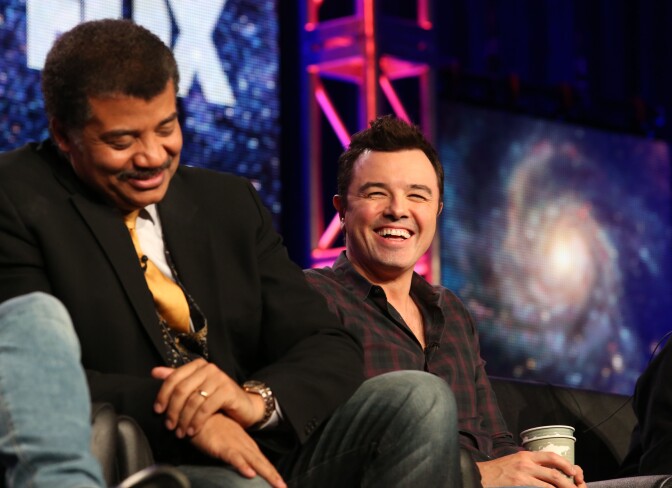 PASADENA, CA - JANUARY 13: Neil DeGrasse Tyson (L) and executive producer Seth MacFarlane speak during the FOX portion of the 2014 Television Critics Association Press Tour at the Langham Hotel on January 13, 2014 in Pasadena, California.  (Photo by Frederick M. Brown/Getty Images)
