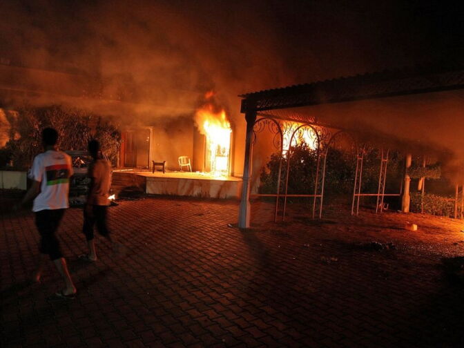 A vehicle (R) and the surrounding buildings burn after they were set on fire inside the U.S. consulate compound in Benghazi late on Sept. 11, 2012.