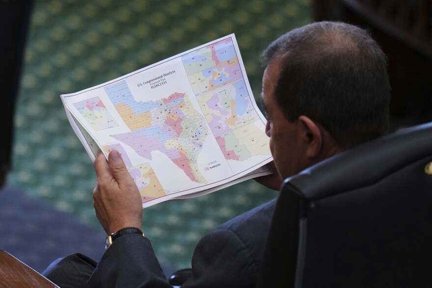 A man is pictured from above holding on to a colorful map.