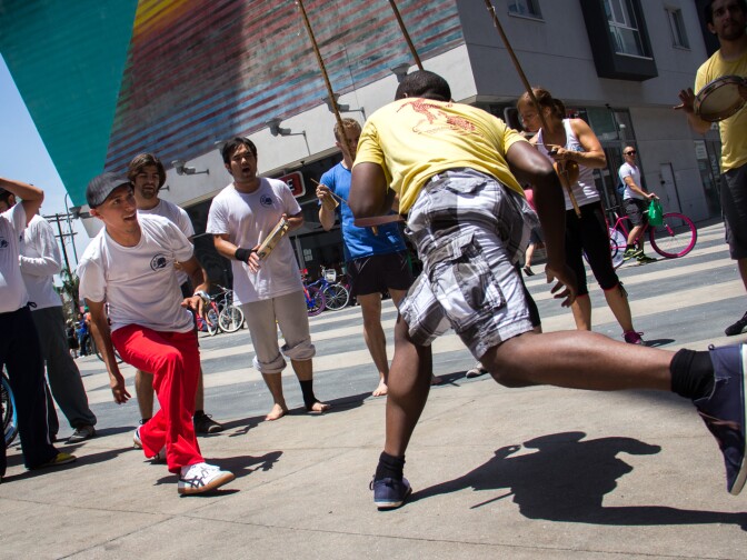 Paolo Flores, left, and his friend, Ope, practice capoeira at Wilshire Boulevard and Vermont Avenue in Koreatown during CicLAvia on June 23, 2013.