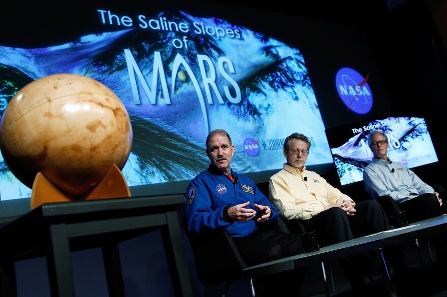 WASHINGTON, DC - SEPTEMBER 28:  John Grunsfeld, associate administrator at NASA's Science Mission Directorate, speaks during a press conference where NASA announced new findings that provide the "strongest evidence yet" of salty liquid water currently existing on Mars, as Jim Green (C), director of planetary science at NASA Headquarters; and Michael Meyer (R), lead scientist for the Mars Exploration Program at NASA Headquarter look on September 28, 2015 in Washington, DC. "Our quest on Mars has been to follow the water in our search for life in the universe, and now we have convincing science that validates what we've long suspected," said Grunsfeld.  (Photo by Win McNamee/Getty Images)