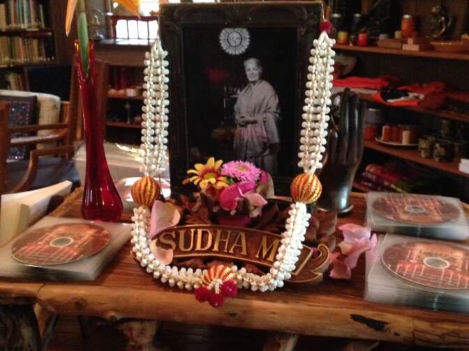 Flowers adorn Sudha Ma's photo in the Ananda Ashrama bookstore, where devotees can purchase recordings of her sermons and copies of her books. 