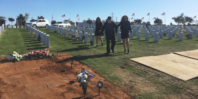Barbara Macias walks her father and daughter toward the gravesite of Jaqueline Macias, who died under the care of Santa Fe Heights, a ReNew Facility. 