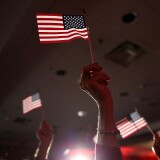 Supporters of  U.S. Rep. Tom Cotton (R-AR) and republican U.S. Senate elect in Arkansas hold American flags during an election night gathering on Nov. 4, 2014 in North Little Rock, Arkansas.