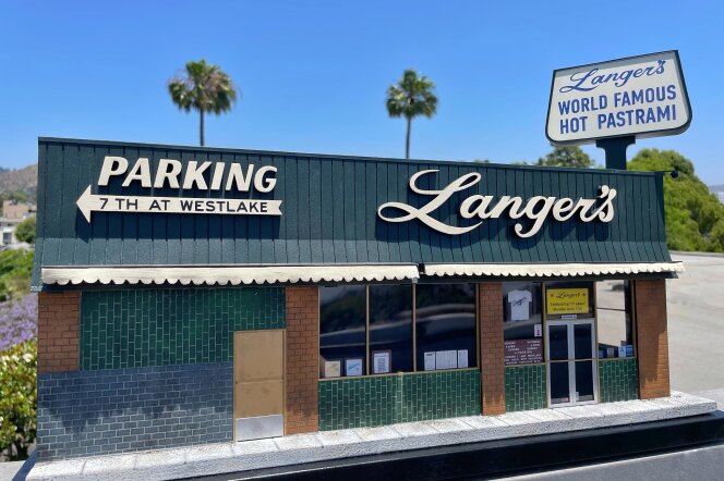 A miniature of a building with green and gray tiles outside, and the name, Langer's on its awning.