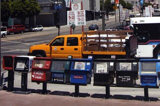 Taking extra newspapers: a black-and-white issue? This row of newspaper vending machines lines 5th street in downtown LA.
