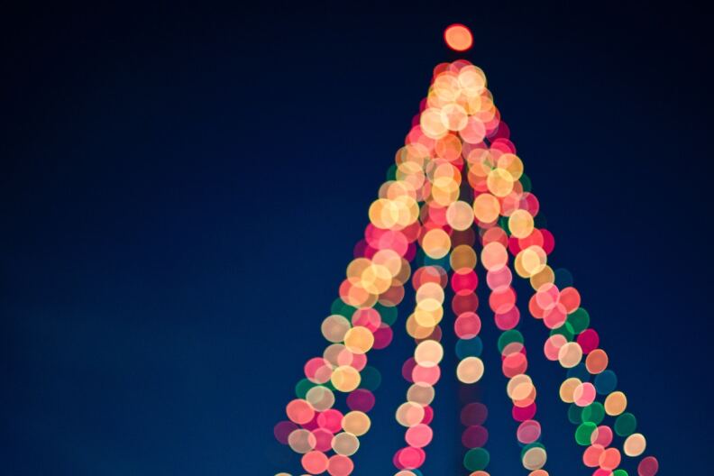 Multicolored lights formed in the shape of a Christmas tree.