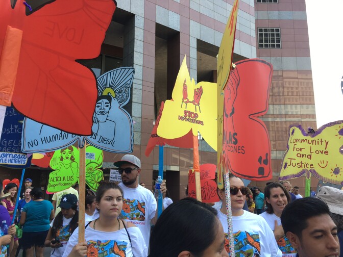 Protestors carry signs in support of DACA at a CHIRLA rally in Downtown Los Angeles on Sept. 1, 2017. 