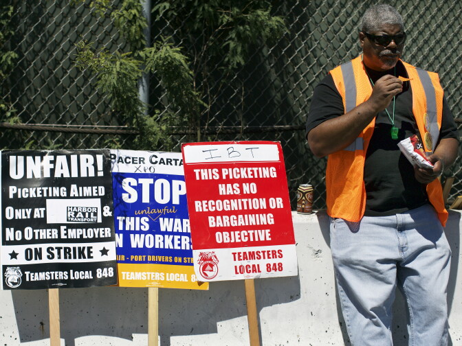 Arthur Bryson, a bus driver who is part of Teamsters Local 848, takes a lunch break while picketing at Pier J in the Port of Long Beach on Monday morning, April 27, 2015. Independent truckers for four companies have gone on strike, asking the four employers to reclassify them as permanent employees so that they can join the Teamsters union.