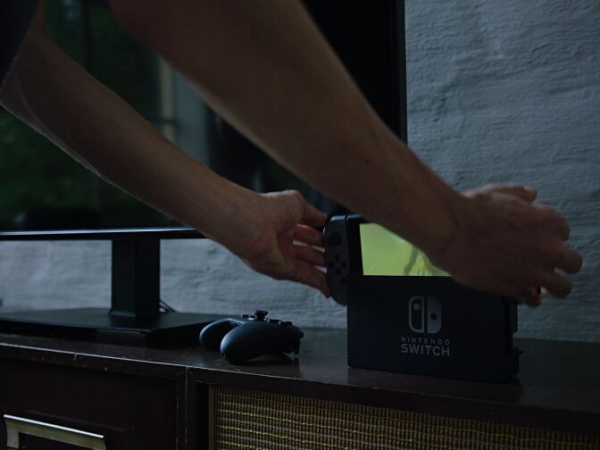 A promotional shot of the Nintendo Switch, a video game console capable of literally being picked up and taken on the move without sacrificing the playing experience.