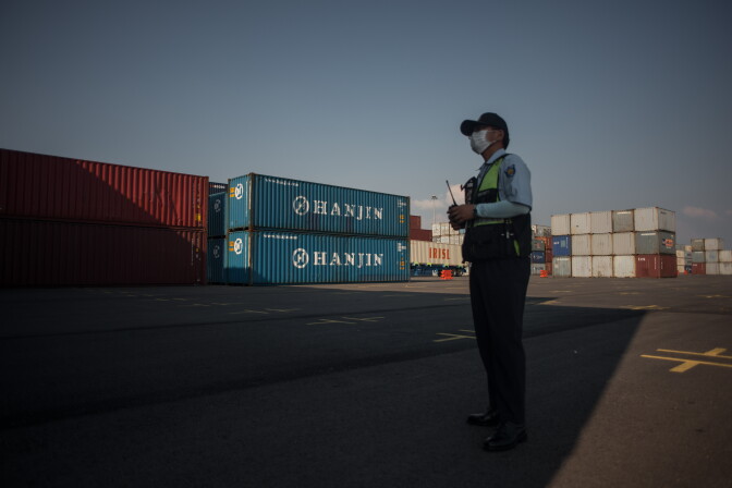 This picture taken on September 3, 2016 shows a security guard standing next to containers at the Hanjin Incheon Container Terminal in Seoul. 
The problems that sank South Korea's Hanjin Shipping this week could be just the tip of the iceberg, analysts say, with the long-running global economic downturn having left the industry drowning in excess capacity. With growth refusing to budge and consumer demand still slack, the world's freight carriers have more ships than they can fill -- a quarter of cargo space lies empty.
 / AFP / Ed Jones / TO GO WITH AFP STORY: Shipping-Logistics-Trade-SKorea-Hanjin / FOCUS by Elizabeth LAW, Martin ABBUGAO        (Photo credit should read ED JONES/AFP/Getty Images)