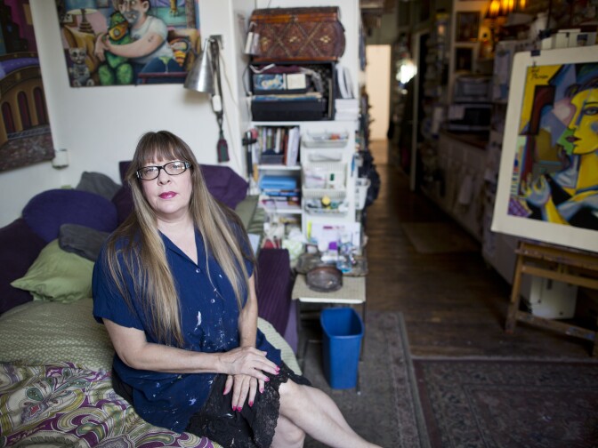 Painter Jett Jackson sits in her 275-square-foot live and work space in the Arts District on Thursday, August 20, 2015. "It's like living on a submarine or a boat," Jackson said of her apartment. "I've spent years compacting."