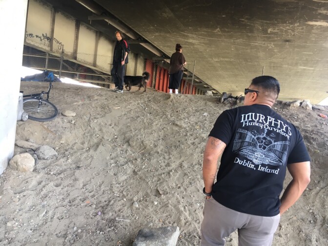Jose Luis Gonzalez, a Marine veteran walks under a bridge in El Monte. He volunteers with the group Vet Hunters, trying to locate and offer services to homeless veterans across Southern California.