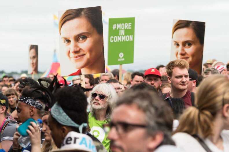 Festival goers hold placards to remember Jo Cox at an event on the Park stage during the Glastonbury Festival at Worthy Farm, Pilton on June 23, 2016 in Glastonbury, England. The Labour MP for Batley and Spen was shot and stabbed in the street on June 16 and later died. A fund set up in her name has raised over £1.23 M GBP to date.  
