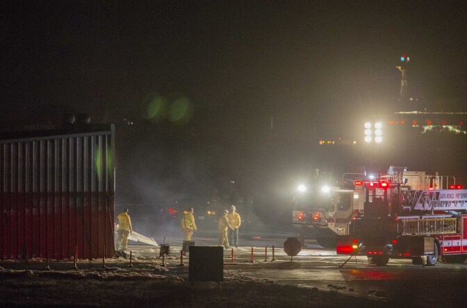 Firefighters work to extinguish fire at the site of a plane crash in Santa Monica, Calif., on Sunday, Sept. 29, 2013. Authorities say a twin-jet Cessna Citation went off the right side of the runway and crashed into a hangar after landing about 6:20 p.m.  It was not immediately clear how many people were on the plane or whether anyone was inside the hangar, and there was no immediate word on any injuries or deaths. (AP Photo/Ringo H.W. Chiu)