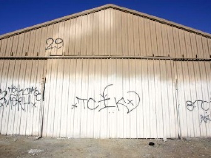 Gang related graffiti on a storefront in South Central Los Angeles, California.