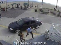In this image take from a security camera, pedestrians scatter as a car drives through a packed afternoon crowd along the Venice Beach boardwalk in Los Angeles, Saturday, Aug. 3, 2013. At least a dozen people were injured, two of them critically, according to police. (AP Photo/Snapchat)
