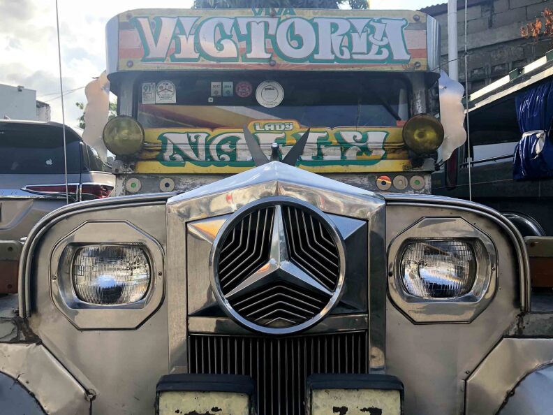 A jeepney adorned with eye-catching lettering sits parked in at a gas station in Calamba, Leguna, about an hour south of the capital Manila. Jeepneys often sport a name, phrase or symbol important to their driver.