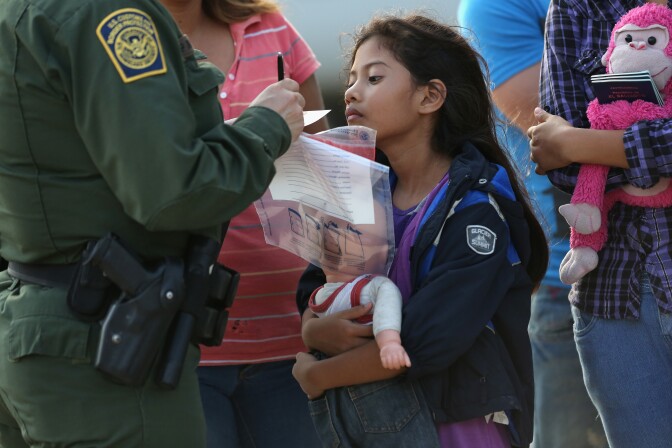 Salvadorian immigrant Stefany Marjorie, 8, watches as a U.S. Border Patrol agent records family information on July 24, 2014 in Mission, Texas. Like most of the recent surge of Central American immigrant women and children, her family brought documents, often birth certificates, to prove their nationality to U.S. Border officials. Tens of thousands of immigrant families and unaccompanied minors from Central America have crossed illegally into the United States this year and presented themselves to federal agents, causing a humanitarian crisis on the U.S.-Mexico border. Texas' Rio Grande Valley has become the epicenter of the latest immigrant crisis, as more of them enter illegally from Mexico into that sector than any other stretch of the America's 1,933 mile border with Mexico.   