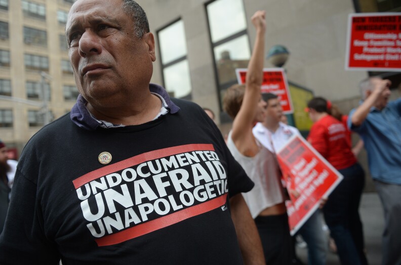 Immigration activists stage a civil disobedience action, blocking a street in front of Varick Street Detention Center, in New York, August 22, 2013. Leaders of immigrant rights group staged the protest against what they call the US unjust deportation policies and lawmakers delaying in passing an immigration reform for some 11 million people living in the US without papers.
