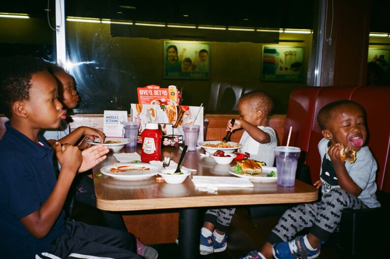 Shammeer's kids eat food at a diner.