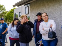 People wait for their turn to get food.