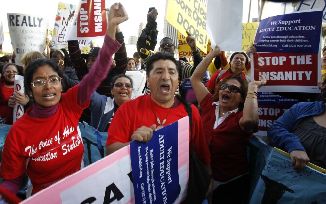 File: Teachers, parents and supporters rally as the Los Angeles Unified School District board meets to consider budget cuts and layoffs, which include adult education, preschool and elementary school arts programs, in Los Angeles on Tuesday Feb. 14, 2012.