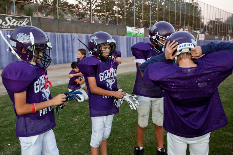 The Glendale Pop Warner team practices at Hoover High School on Wednesday. Coach Dave Marks is teaching his players how to tackle differently for safety reasons.