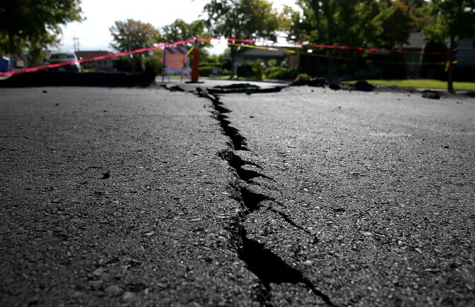 File: A crack runs down the center of an earthquake-damaged street on Aug. 26, 2014 in Napa, California.