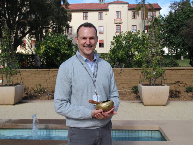 Clinical psychologist Dr. Greg Serpa stands in the garden outside his office at the West Los Angeles VA. 