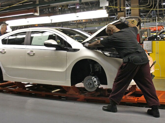 Workers assemble a Chevrolet Volt at GM's Detroit Hamtramck Assembly Plant in October. The auto maker says it will idle the plant for five weeks, to allow demand to catch up with inventory.