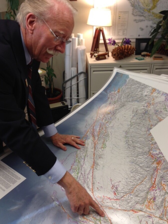 John Parrish shows off a state map with 15,000 faults on it. He says there are likely many more faults that have not yet been discovered.